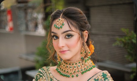 Bride in green and gold jewellery with marigold flowers