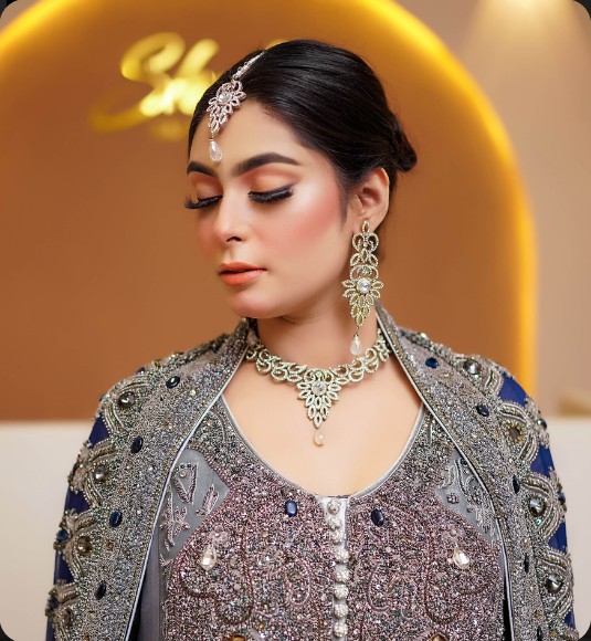 Bride in grey embellished outfit with statement earrings